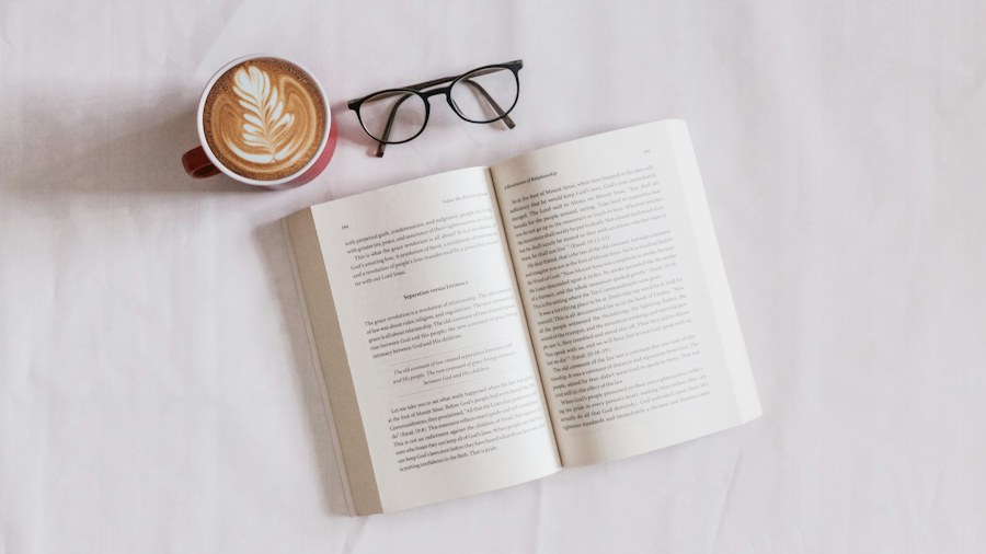 An open book and reading glasses on a desk
