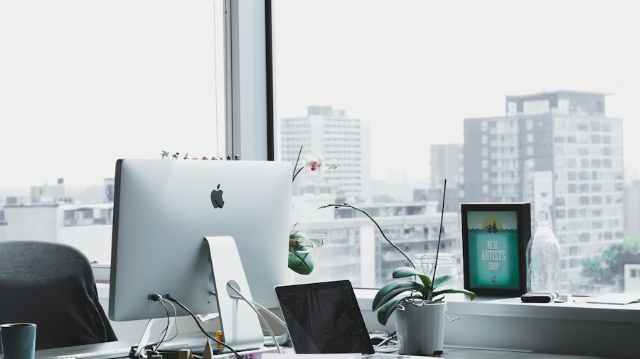 A clear and organized office desk by a window