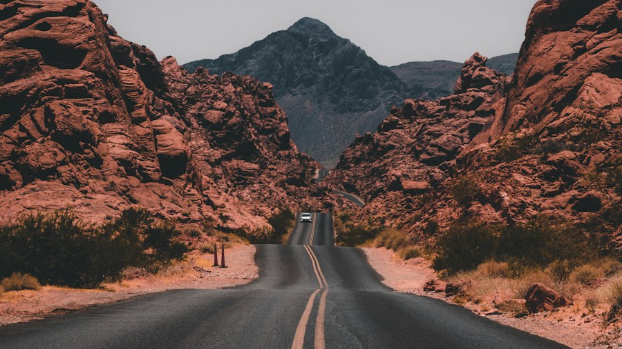 A road leading between red rock formations