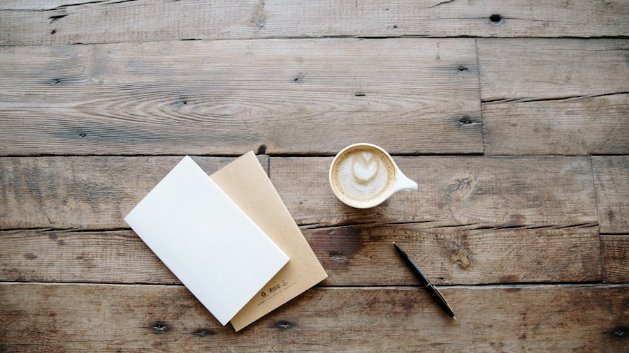A notebook and cup on a quiet wooden study table