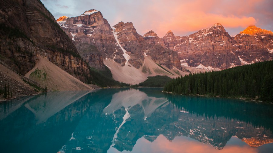 Mountains reflected in clear turquoise water