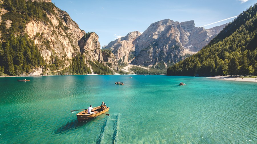 A small boat on a clear mountain lake
