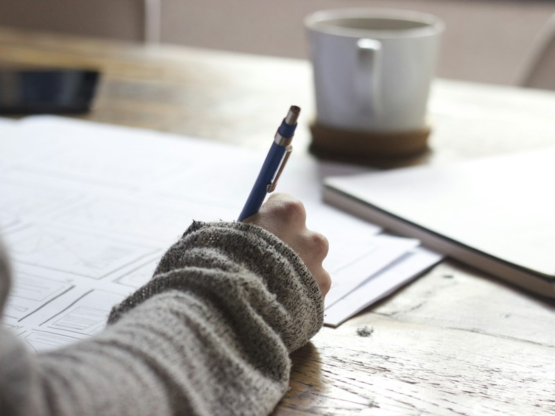 A learner writing notes